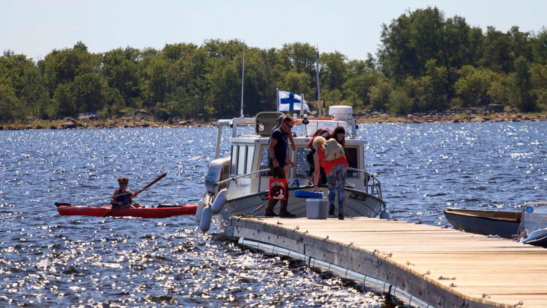Passengers boarding the boat at the end of the pier.
